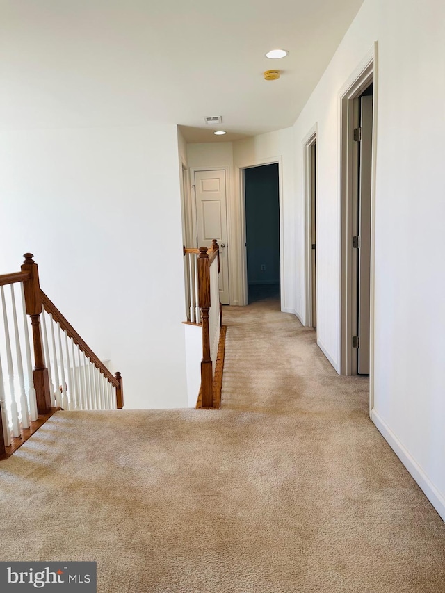 corridor featuring light carpet