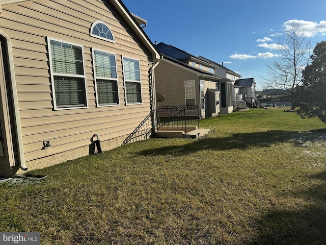 view of side of home with a lawn