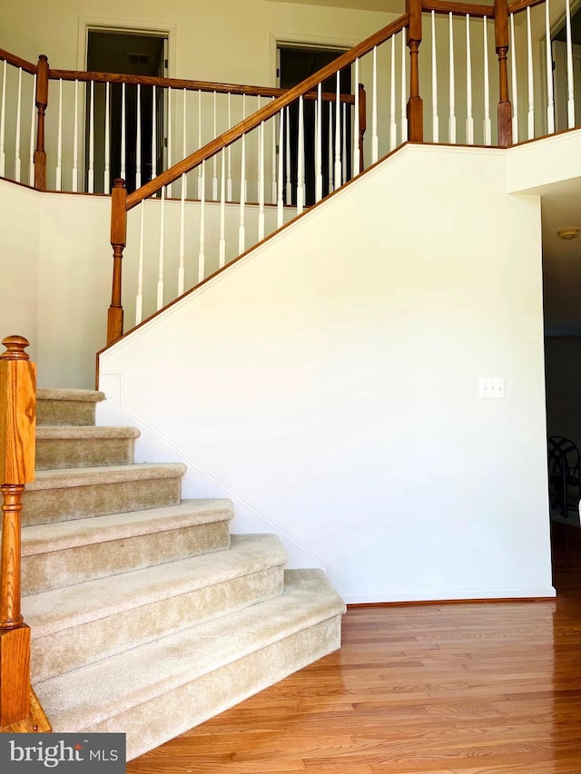 stairs featuring hardwood / wood-style flooring