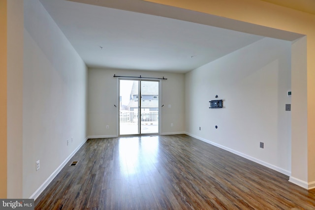 spare room with dark hardwood / wood-style flooring