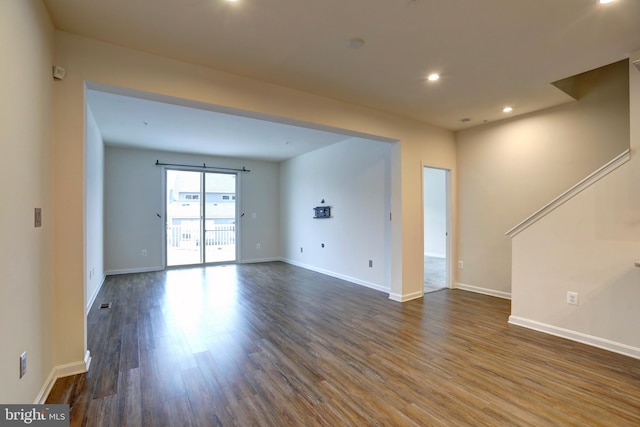 spare room with dark wood-type flooring