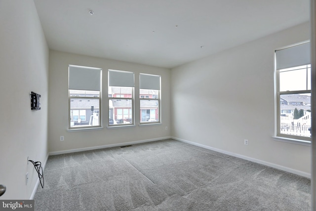 spare room with light carpet and a healthy amount of sunlight