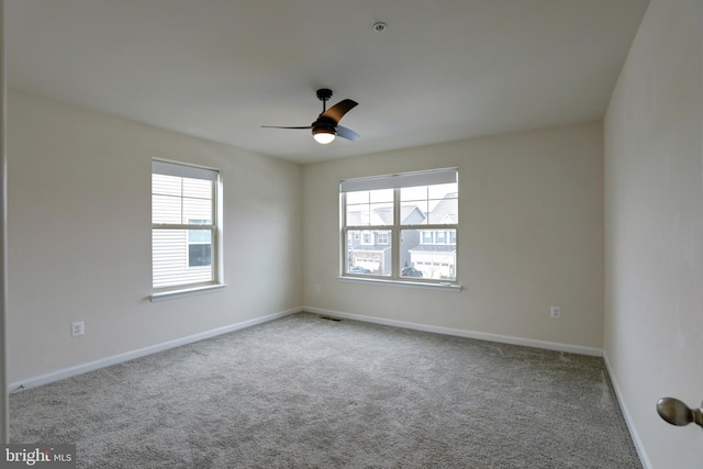 unfurnished room featuring ceiling fan and light carpet