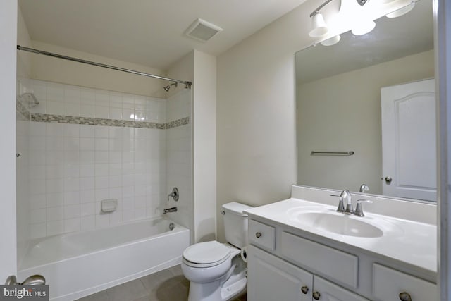 full bathroom with toilet, tile patterned flooring, tiled shower / bath, and vanity