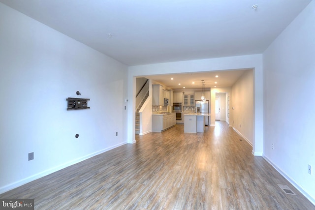 unfurnished living room with hardwood / wood-style flooring