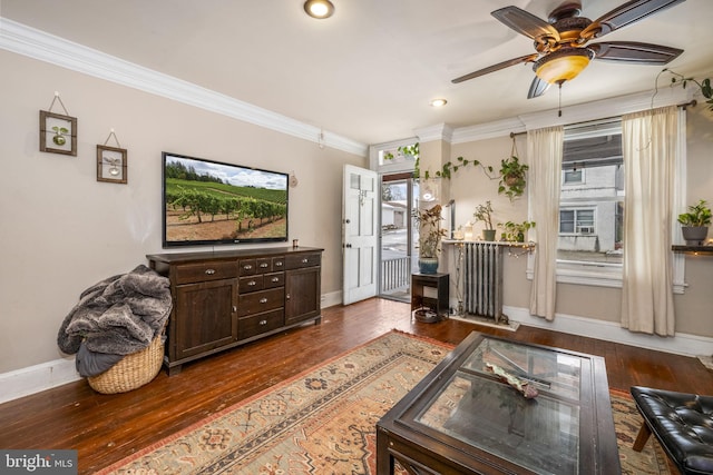 living room featuring ornamental molding, ceiling fan, and dark hardwood / wood-style floors