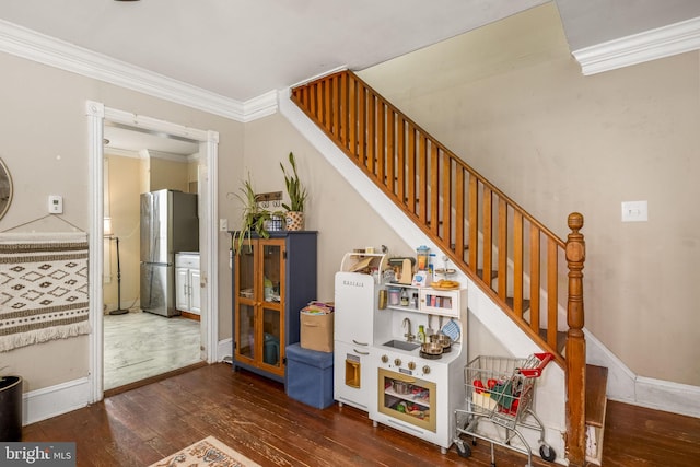 stairway with ornamental molding and wood-type flooring