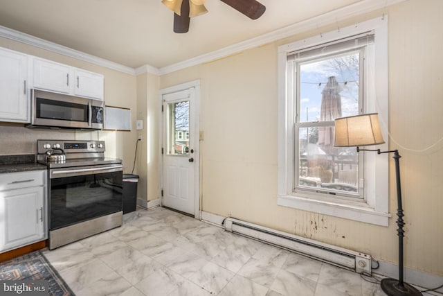 kitchen featuring a baseboard heating unit, a healthy amount of sunlight, white cabinetry, and appliances with stainless steel finishes