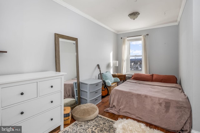 bedroom with hardwood / wood-style flooring and crown molding