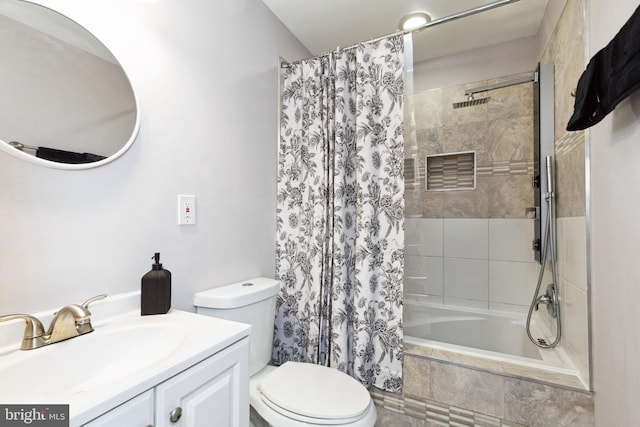 bathroom featuring tiled shower / bath combo, vanity, and toilet