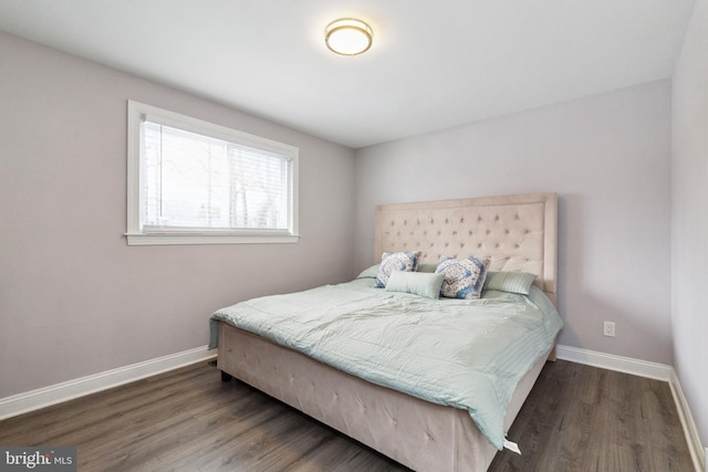 bedroom featuring baseboards and wood finished floors