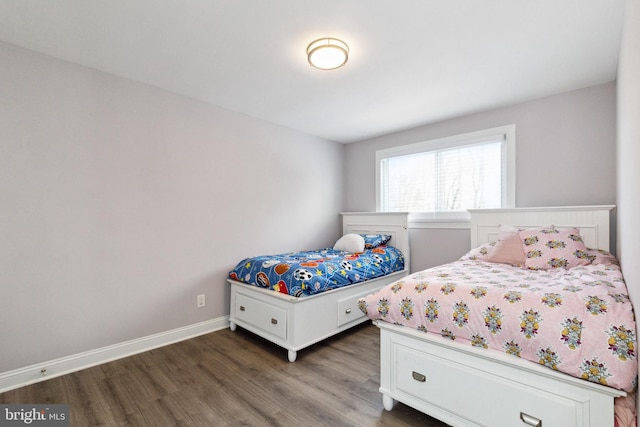 bedroom with wood finished floors and baseboards