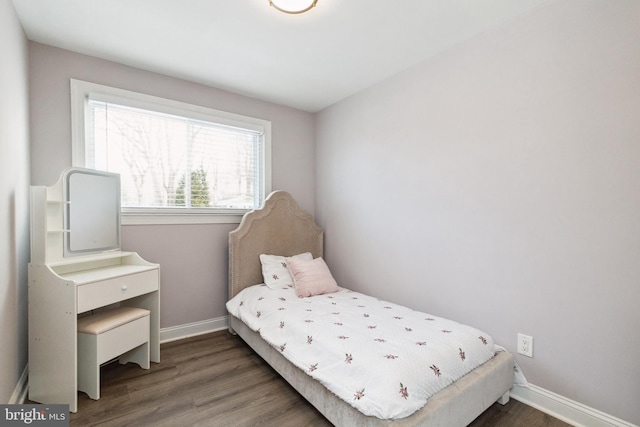 bedroom with baseboards and wood finished floors