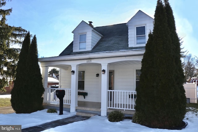 cape cod home with a porch