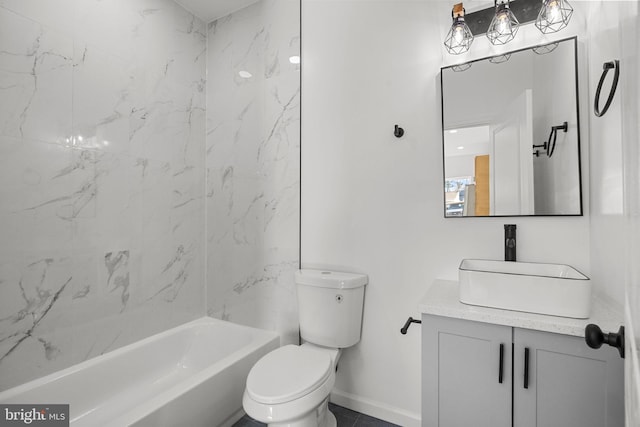 full bathroom featuring toilet, tiled shower / bath combo, and vanity