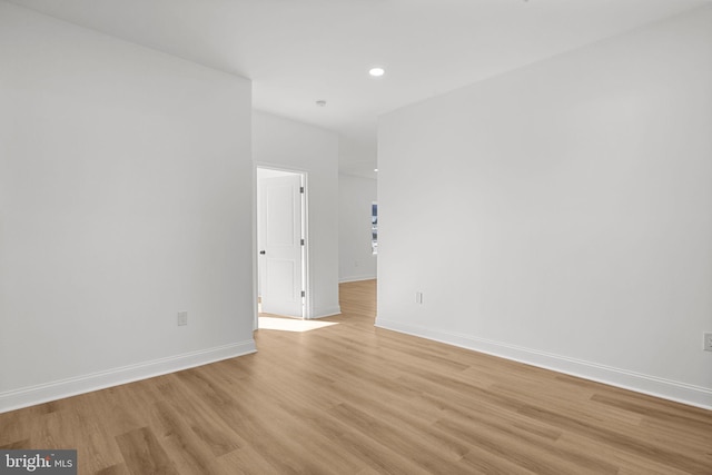 empty room with light hardwood / wood-style flooring