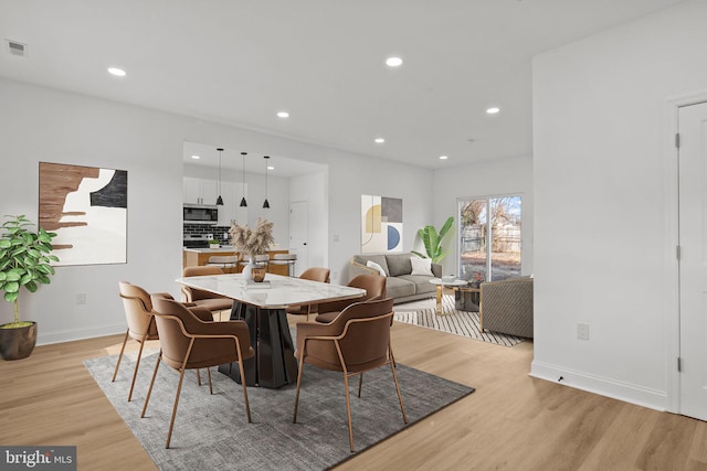 dining area with light hardwood / wood-style floors