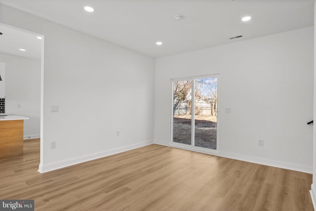 spare room with light wood-type flooring