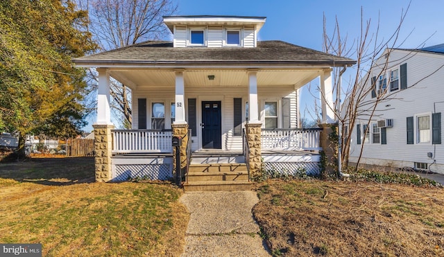 bungalow featuring a front lawn and covered porch