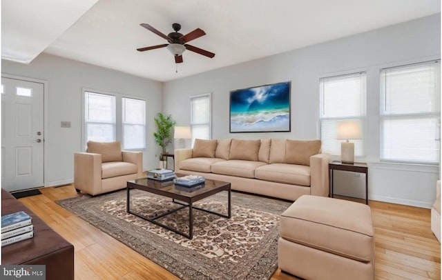 living room with ceiling fan and light hardwood / wood-style flooring