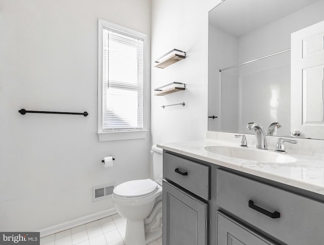 bathroom with a wealth of natural light, toilet, and vanity