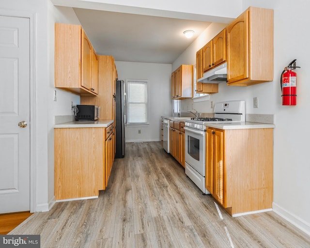 kitchen featuring white appliances and light wood-type flooring