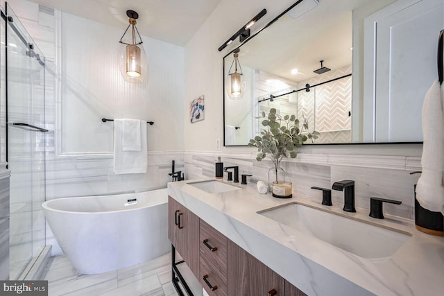 bathroom with plus walk in shower, tile walls, and vanity