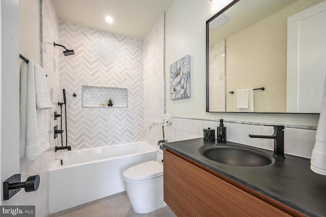 full bathroom featuring tasteful backsplash, tiled shower / bath, vanity, and toilet