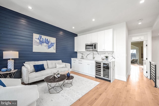 living room featuring light hardwood / wood-style floors and beverage cooler