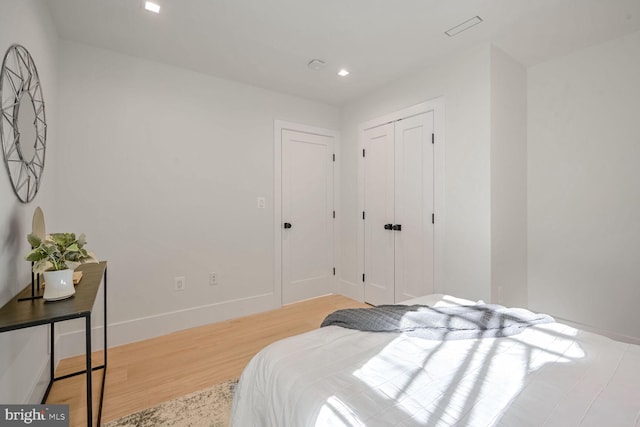 bedroom with a closet and light hardwood / wood-style floors