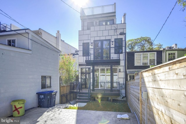 back of property featuring a balcony