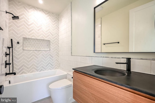 full bathroom featuring tile walls, toilet, vanity, and tiled shower / bath