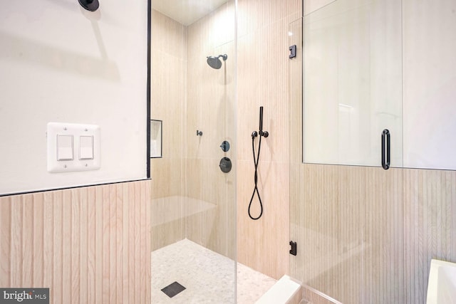 bathroom featuring a shower with shower door