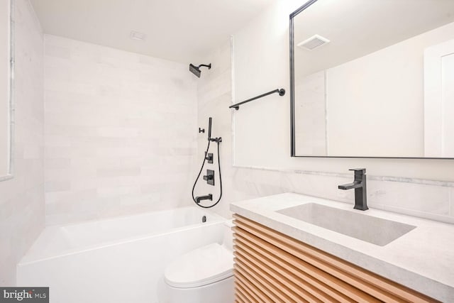 full bathroom featuring toilet, tiled shower / bath combo, and vanity