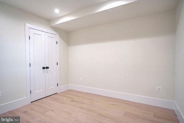 unfurnished bedroom featuring a closet and light hardwood / wood-style floors