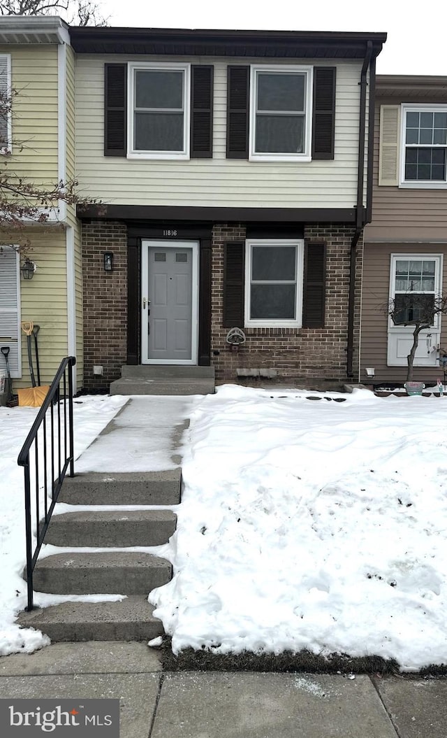 view of snow covered property entrance