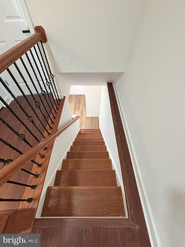 staircase featuring hardwood / wood-style flooring