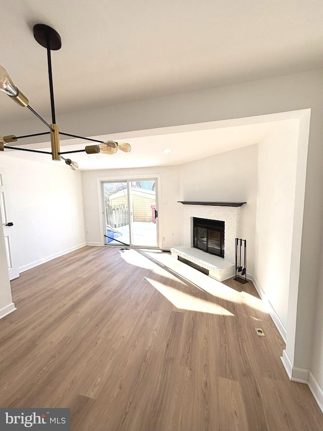 unfurnished living room featuring a fireplace and wood-type flooring