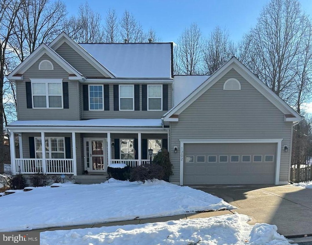 view of front of property with covered porch and a garage