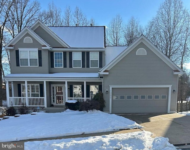 view of front of property with covered porch and a garage