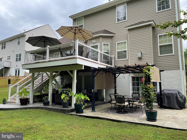 rear view of property with a wooden deck, a patio area, a yard, and a pergola