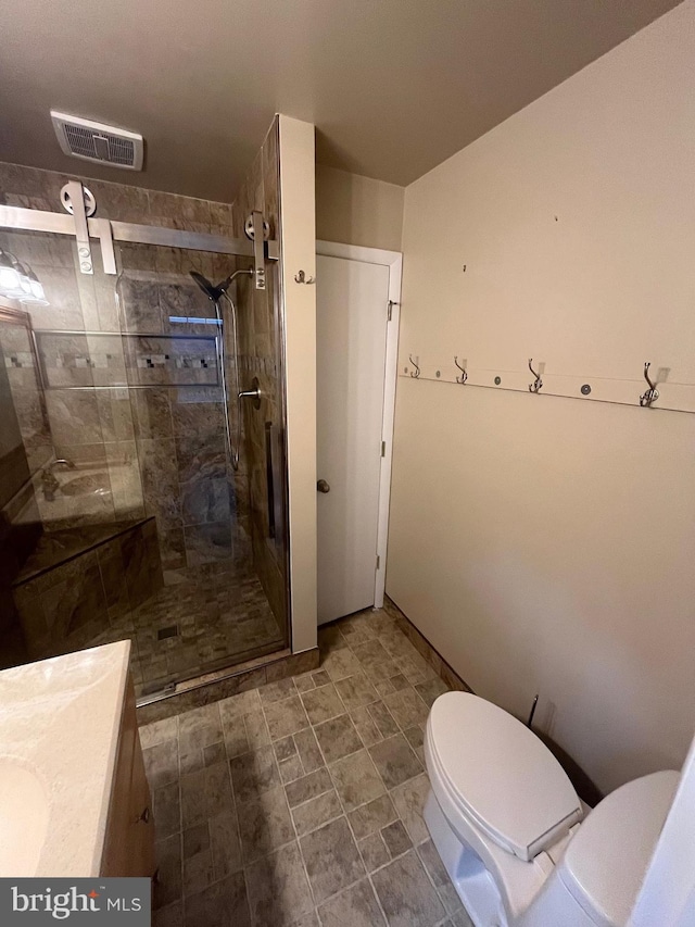 bathroom featuring vanity, toilet, and walk in shower