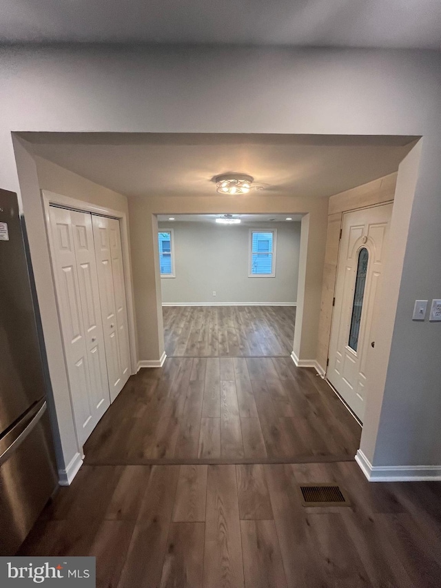 corridor with dark wood-type flooring