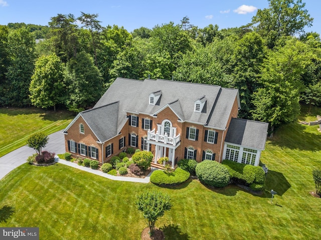 colonial-style house with a front yard