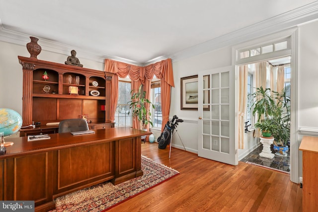 office with ornamental molding and light hardwood / wood-style floors