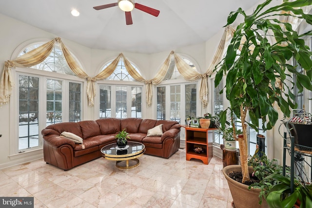 sunroom featuring ceiling fan and lofted ceiling