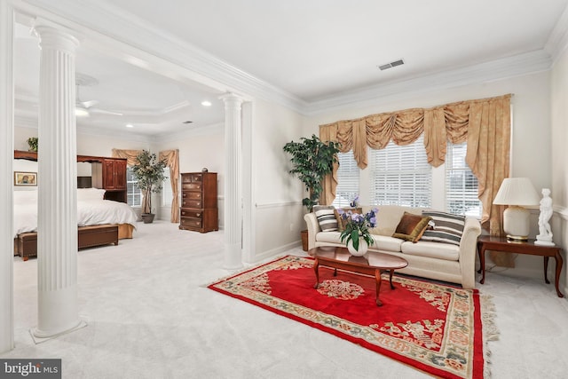 living area with ornate columns, crown molding, and carpet floors