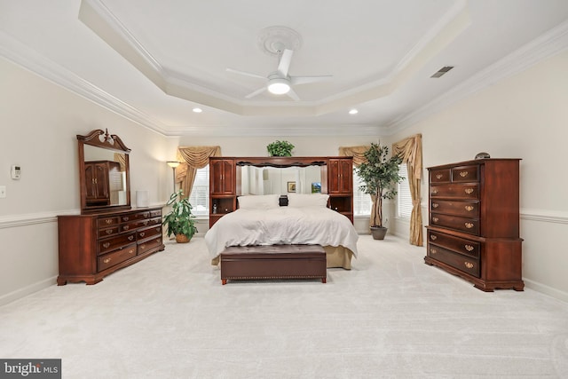 bedroom featuring light carpet, ceiling fan, crown molding, and a raised ceiling