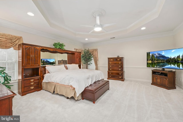 bedroom featuring a raised ceiling, ceiling fan, light carpet, and ornamental molding