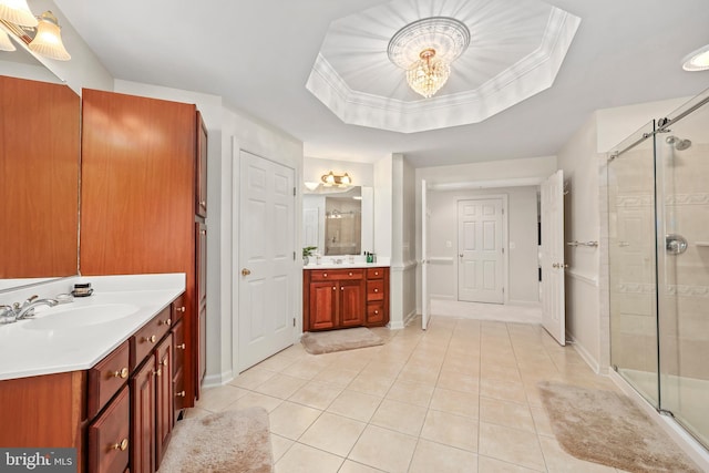 bathroom with vanity, tile patterned flooring, a shower with door, and a tray ceiling